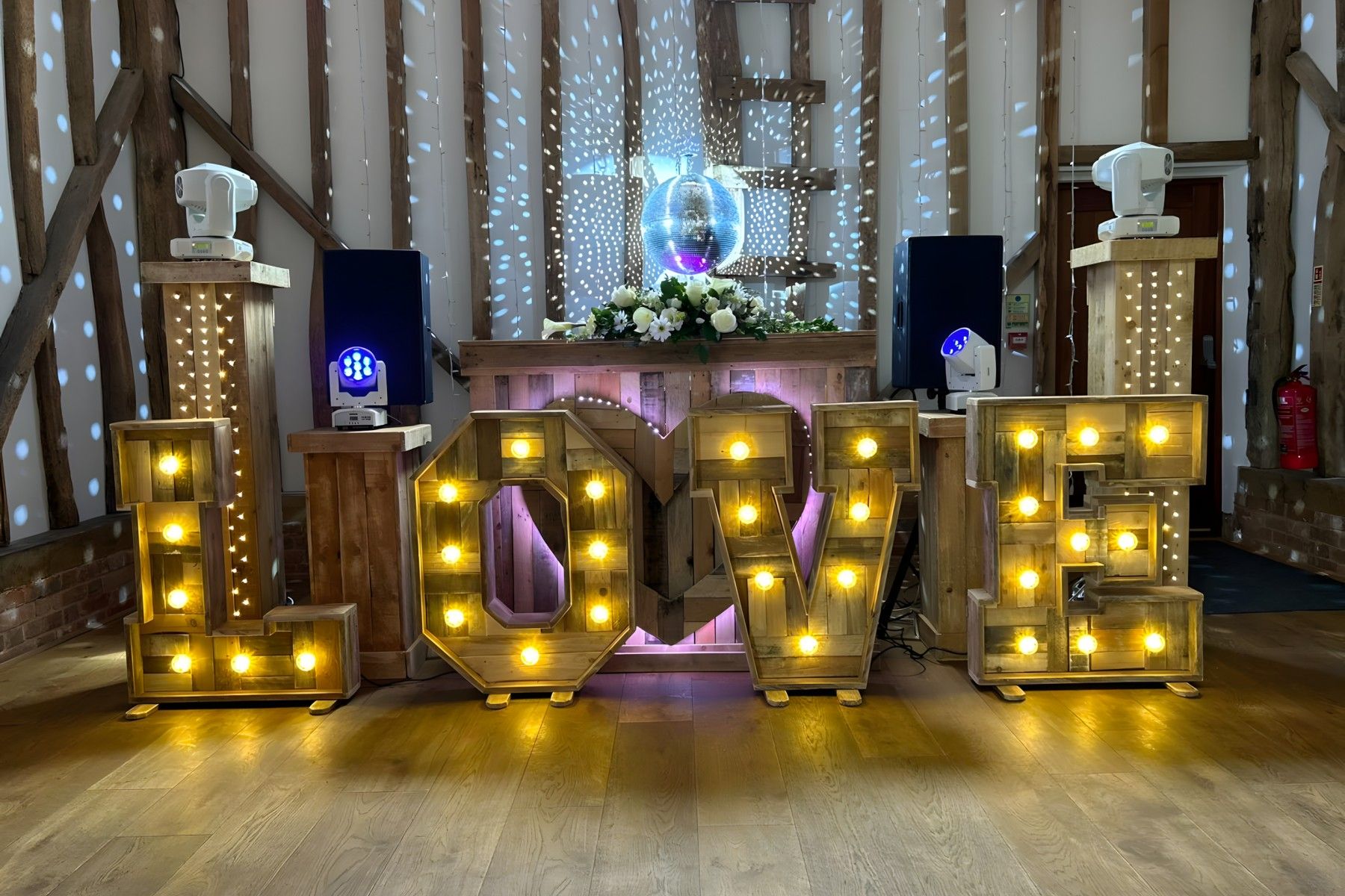 Marky T's wedding setup with "Love" in letters, disco lights, and big speakers